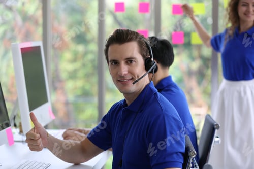 Preview: male tech support operator with blue t-shirt uniform and black headset