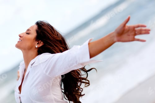 Preview: Woman Relaxing At The Beach With Arms Open Enjoying Her Freedom