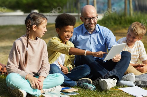 Preview: Multi-Ethnic Group of Kids with Teacher Outdoors