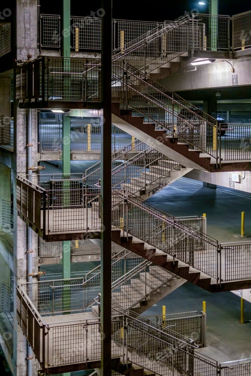 Preview: The stairwell in a parking garage in a city, at night.
