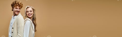Preview: happy young couple in light-colored stylish attire posing back to back on beige backdrop, banner