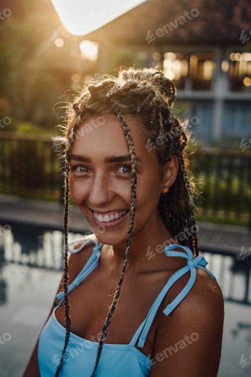 Preview: Joyful woman with dreadlocks in bali hotel