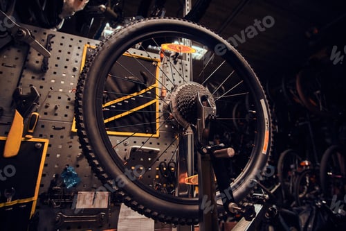 Preview: Busy workshop with broken mountain bicycle on the table