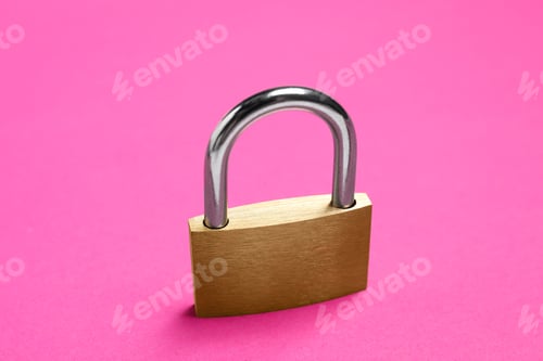Preview: One locked steel padlock on pink background, closeup
