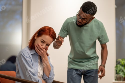 Preview: Nervous angry husband black man screaming try to explain prove something to hysterical woman wife.