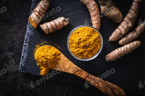Preview: Indian turmeric powder and root. Turmeric spice. Ground turmeric.