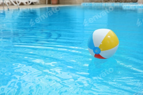 Preview: Colorful inflatable ball floating on water in swimming pool