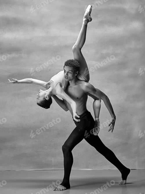 Preview: Couple of ballet dancers posing over gray background