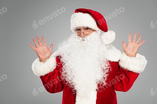 Preview: Santa claus in eyeglasses and costume waving hands isolated on grey