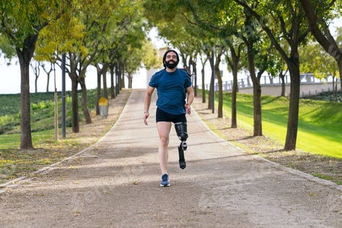 Preview: Joyful Amputee Athlete Running in Park with Prosthetic Leg