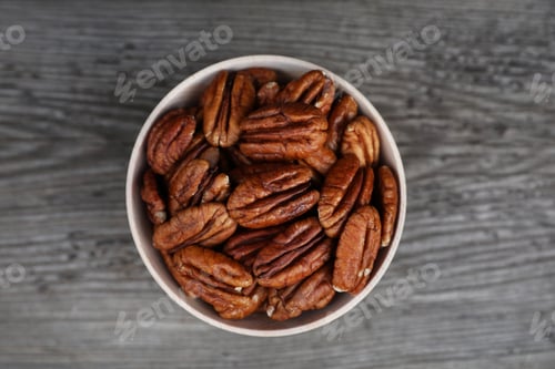 Preview: Tasty pecan nuts on grey wooden table, top view