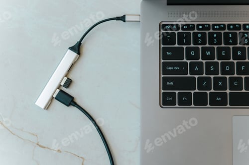 Preview: Close up of type c usb hub with multiple different ports connected to laptop
