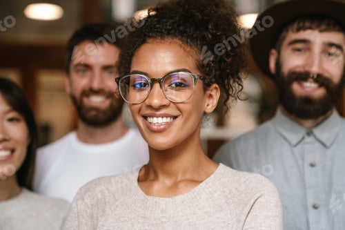 Preview: Image of multiethnic young business workers standing together at office