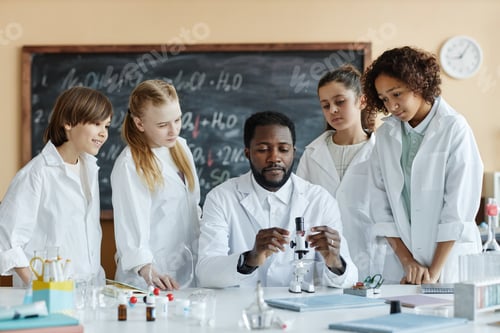Preview: Young Black Man Teaching Kids How To Use Microscope