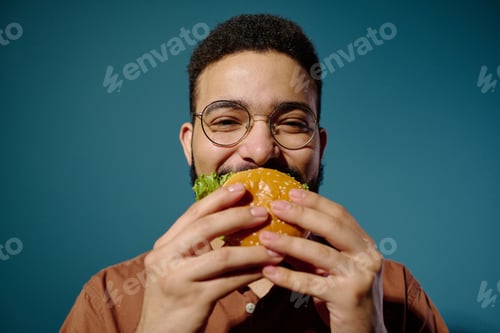 Preview: Portrait of Man Enjoying Delicious Burger with Joyful Expression