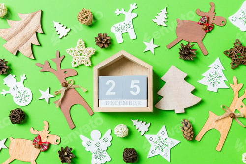 Preview: Christmas green background with holiday toys and decorations. Top view