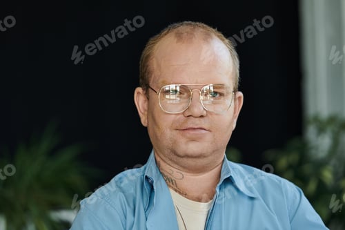 Preview: A Mans Focused Gaze Through Glasses