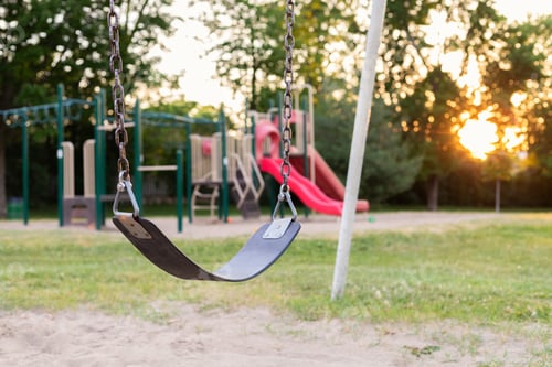 Preview: Playground and swing in the park without people during sunset in summer in Ottawa, Canada