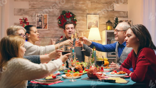 Preview: Little daughters sitting at the table with adults