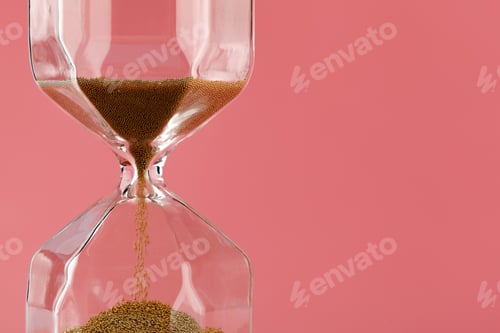 Preview: Close up of sandglass on paper background