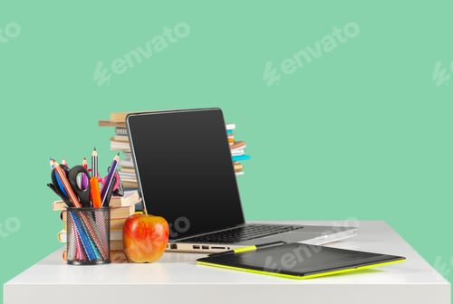 Preview: Laptop and Study Materials on a White Desk
