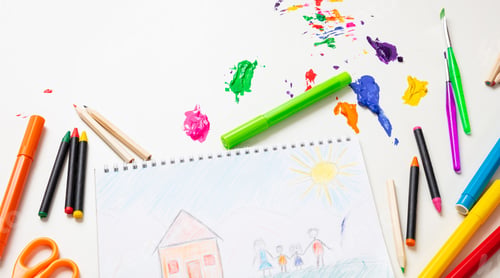 Preview: Colorful paints and family home drawing on white color background, top view