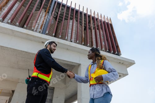 Preview: Engineering and foreman shaking hands on construction site and Agree. partnership and connection.