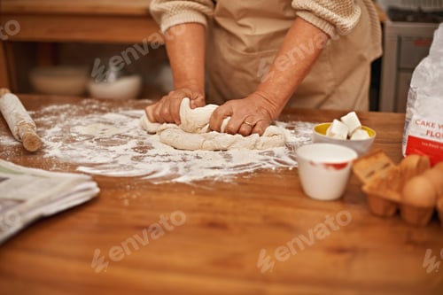 Preview: Made with love...A cropped view of hands working the dough while baking in a kitchen.