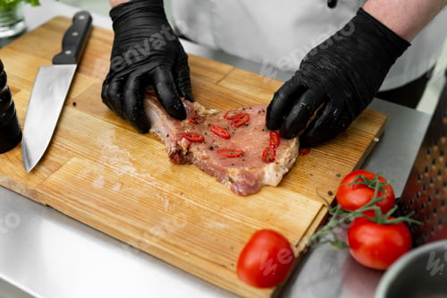 Preview: The chef adds salt with his hands and marinates the raw meat before grilling it.