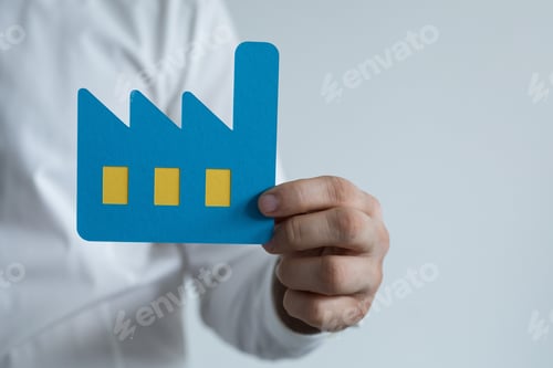 Preview: Sign of a factory made of blue paper in the hands of a man