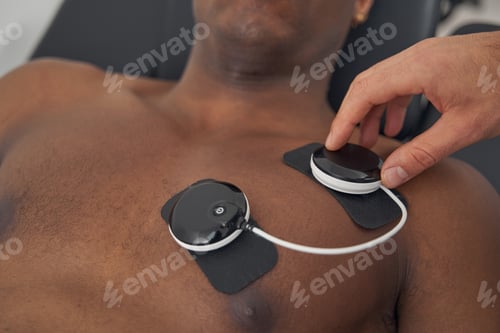 Preview: Doctor preparing African American man for EMS session