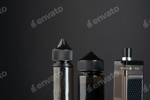 Preview: Vape and vape liquid bottles against black background