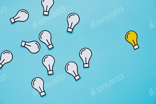 Preview: top view of paper light bulbs scattered on blue background, business concept