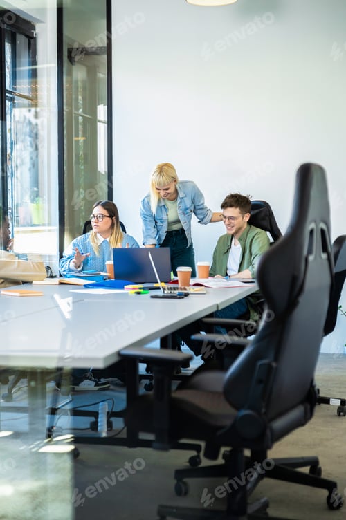 Preview: Diverse group of young business people working on new project together in office.