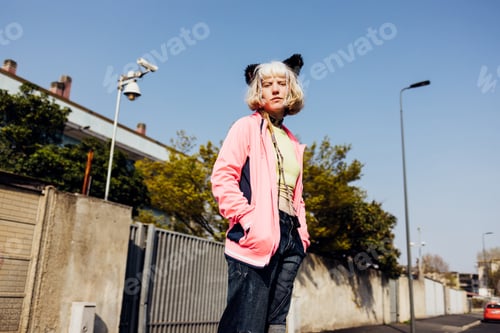 Preview: Diverse non binary woman posing outdoor looking camera serious and confident