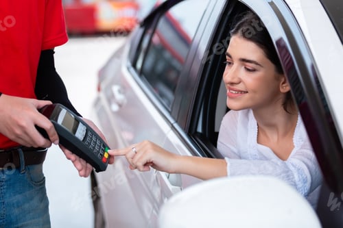 Preview: Woman in car paying card reader payment terminal after refuel car.