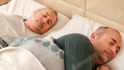 Preview: Mature gay couple waking up in bed in the morning