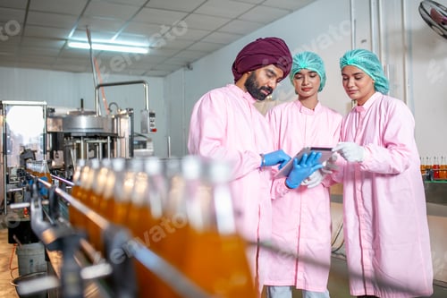 Preview: Group of Asian worker with clipboard is checking product bottles in the beverage factory.