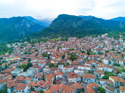 Preview: Greek town of Litochoro with small houses against the backdrop of the Mount Olympus and a cloudy sky