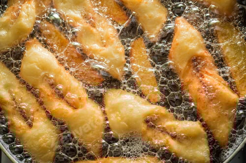 Preview: Frying delicious and traditionally donuts on hot oil