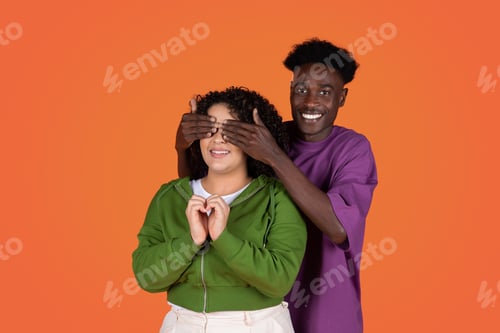 Preview: Black man standing behind his girlfriend and closing her eyes