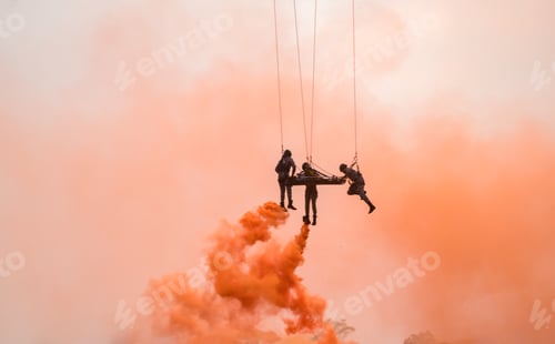 Preview: Medics airlift an injured soldier beneath a hovering helicopter using ropes and smoke cover