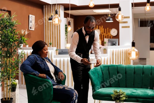 Preview: Hotel waiter serving coffee to guest