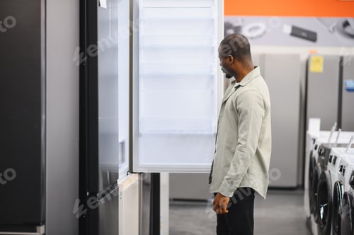 Preview: Customer choosing refrigerator in electronics store appliance department