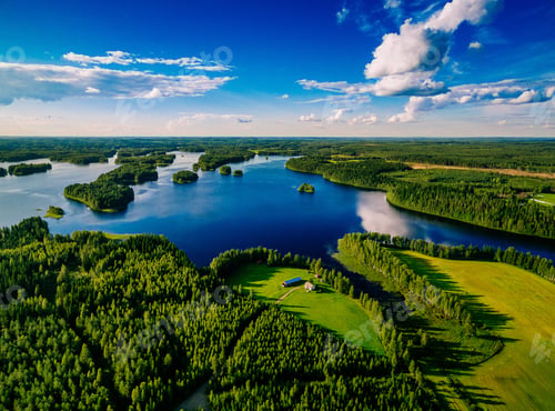 Preview: Aerial view of blue lakes and green forests on a sunny summer day in Finland.