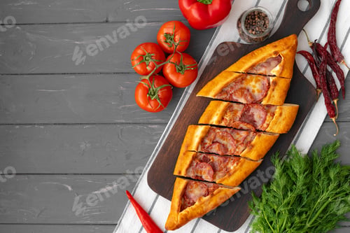 Preview: Turkish stuffed flatbread pide on gray wooden table