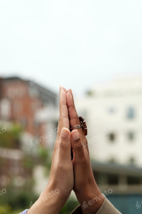 Preview: Unrecognizable women doing a high five outdoors.