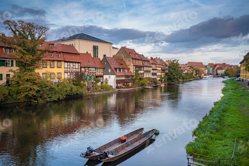 Preview: Germany, Bavaria, Bamberg, Boats moored in river with townhouses in background
