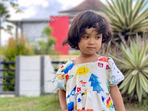 Preview: Kid smiling standing in the garden
