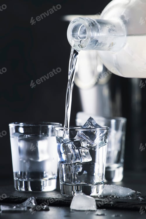Preview: Vodka in shot glasses pouring out of the bottle